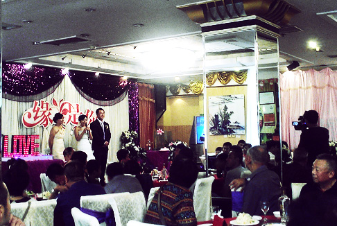 Chinese Wedding Ceremony: The Bride and Groom Perform Rituals in Front of the banquet hall